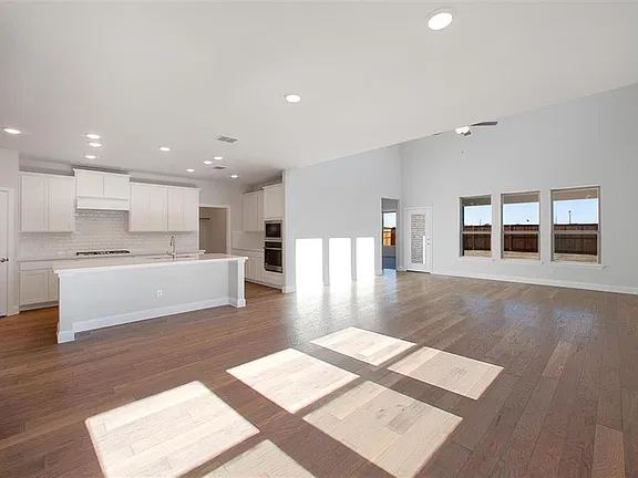 Open kitchen and living area with wood-look floors