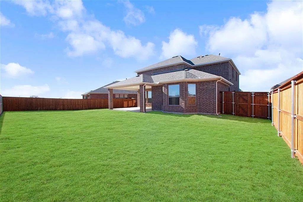 Large fenced backyard lawn